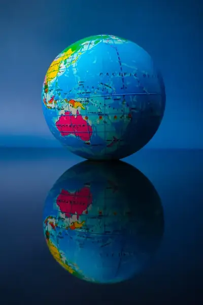 earth-globe-with-reflection-on-a-black-acrylic-boa-2024-12-08-00-12-20-utc