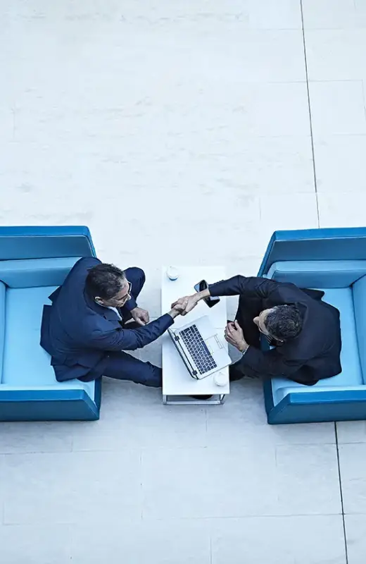 overhead-view-of-businessmen-shaking-hands-in-offi-2024-10-18-10-13-39-utc